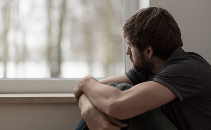 what is dual diagnosis? - depressed man looking out window