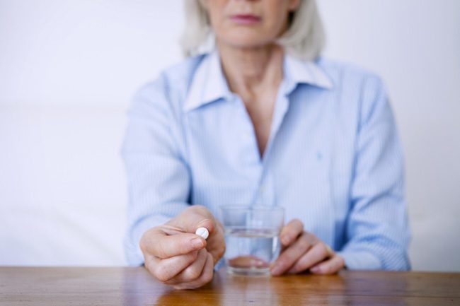 Seniors-and-Substance-Abuse--A-Growing-Problem - senior woman holding pill about to take