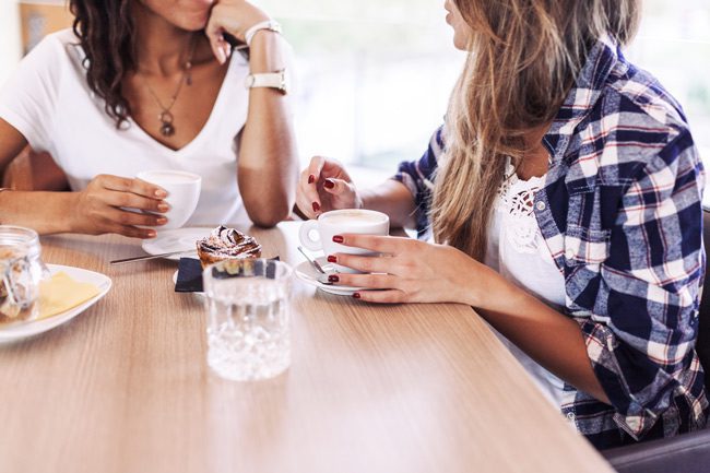 two woman talking over coffee - amends